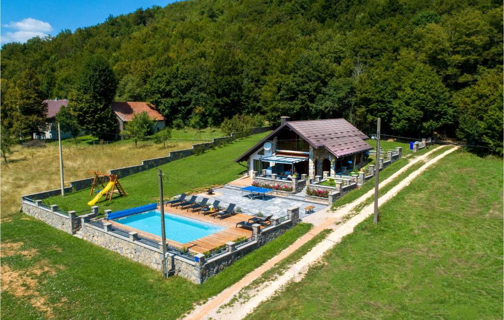 an aerial view of a house with a swimming pool at Stunning Home In Gospic With Outdoor Swimming Pool, Wifi And 2 Bedrooms in Gospić