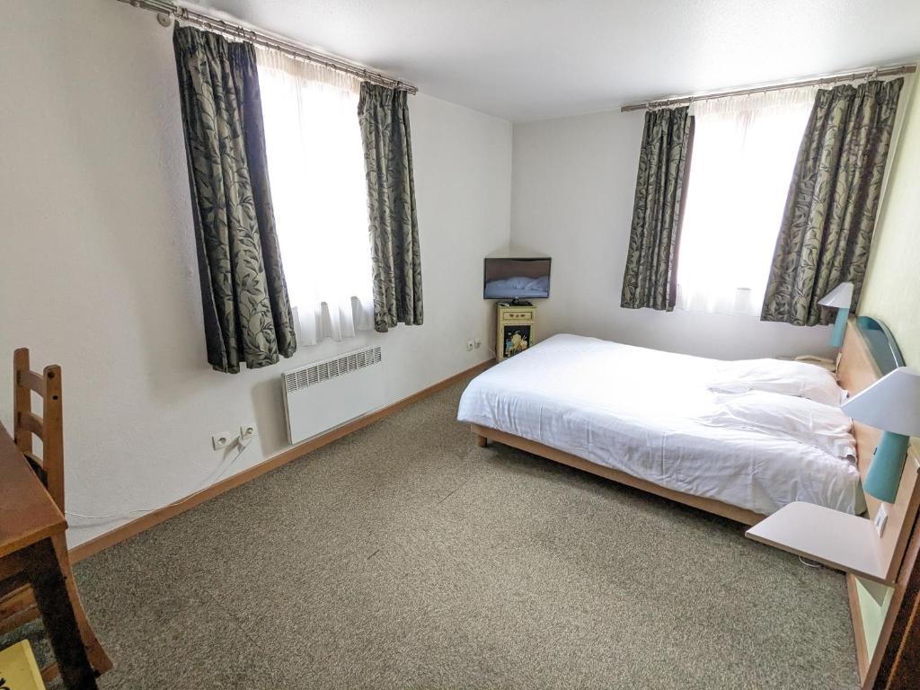 Postel nebo postele na pokoji v ubytování Hotel le Chasseur