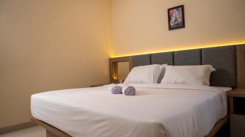 Postel nebo postele na pokoji v ubytování Hotel Luansa Klui