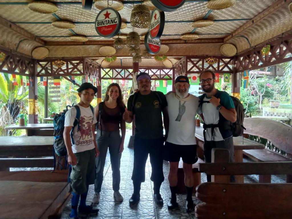 a group of people posing for a picture at Jungle treking & Jungle Tour booking with us in Bukit Lawang