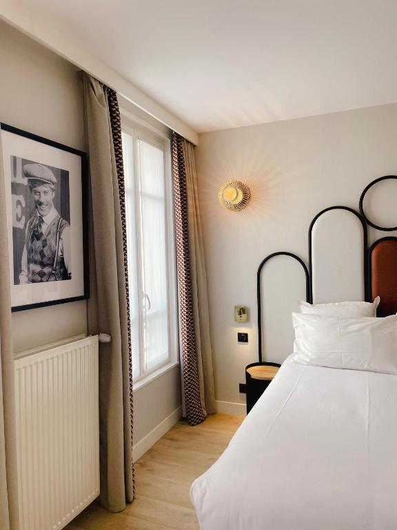 Кровать или кровати в номере Hôtel de L'Esperance