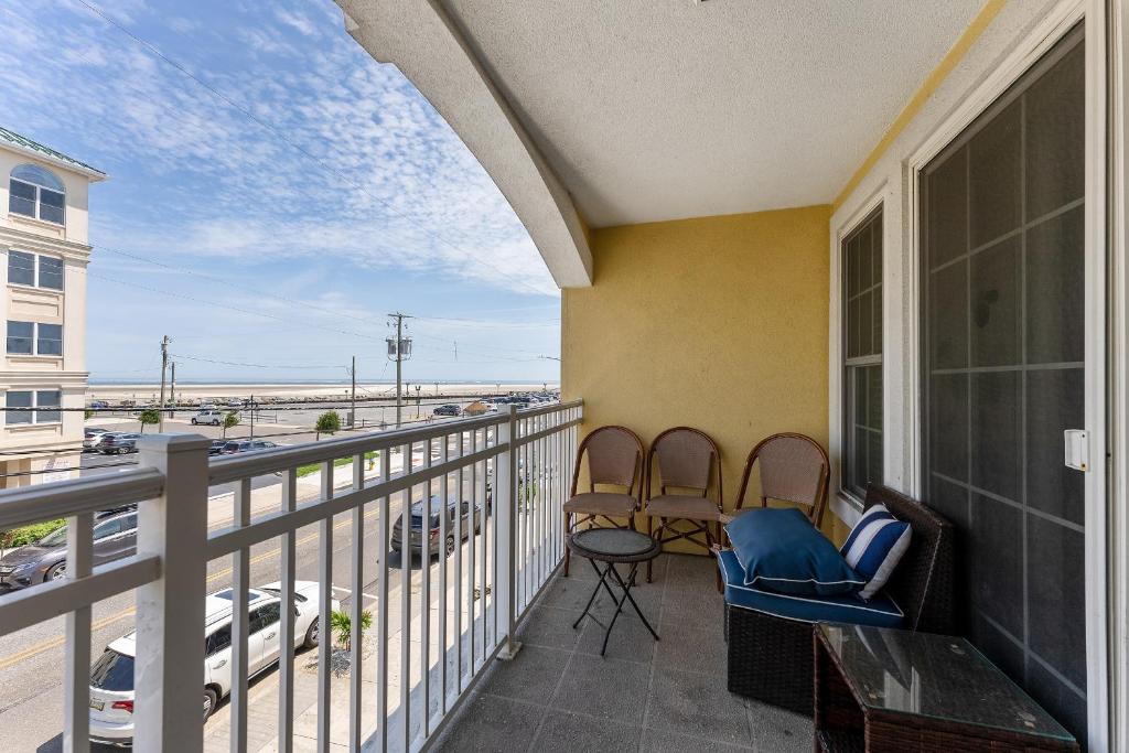 a balcony with two chairs and a view of a street at Nw Vacation Rental Condo W Pool & Ocean Views in North Wildwood