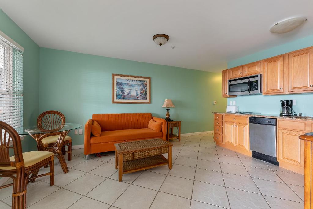 a kitchen and living room with a couch and a table at Nw Condo Across Beach Pool & Parking in North Wildwood