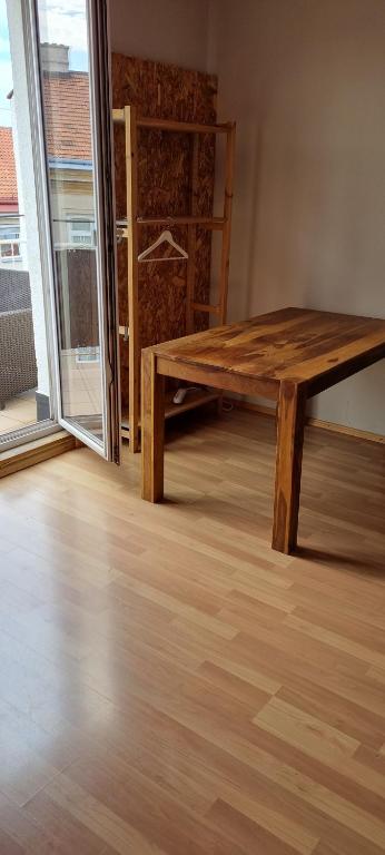 a wooden table in a room with a large window at Apartment free WiFi in Breitenau am Hochlantsch