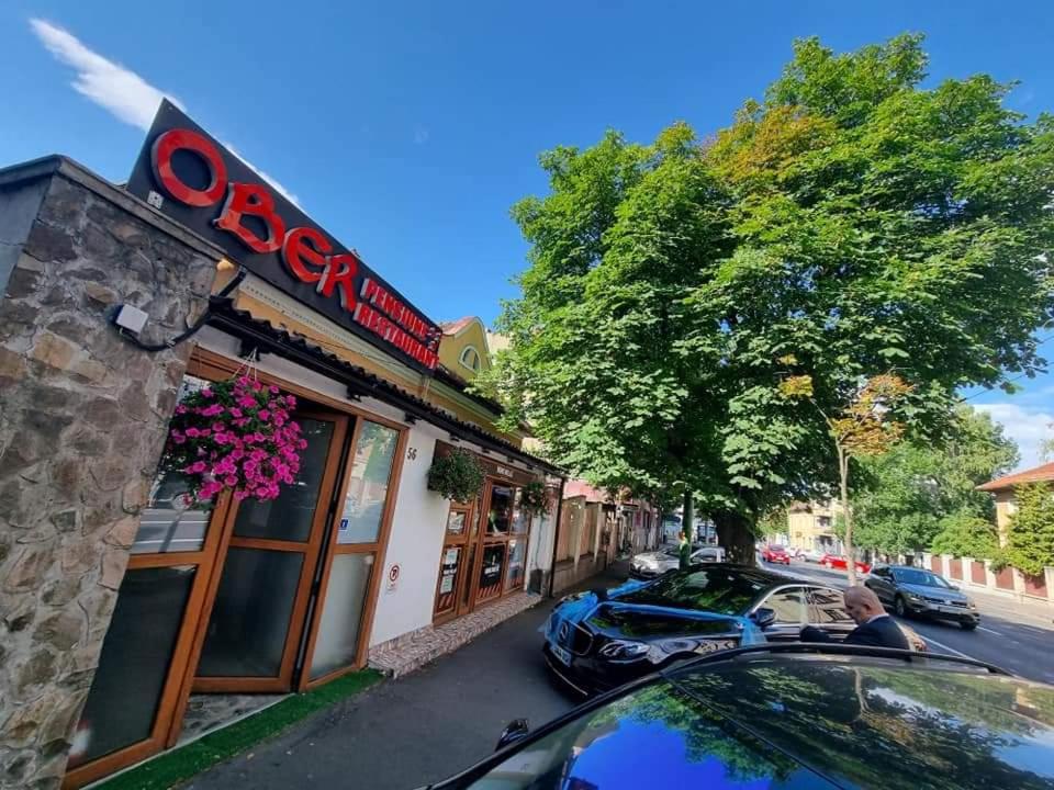 a car parked in front of a store at Pensiunea ober in Braşov