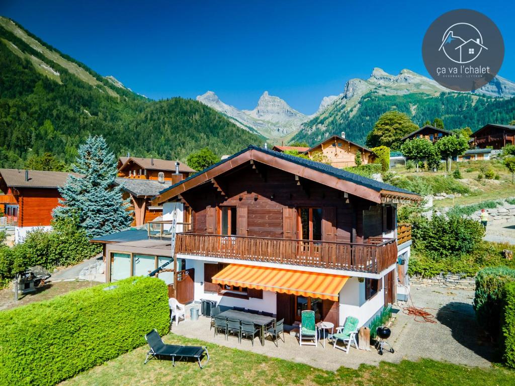 a house with a balcony and a mountain in the background at Chalet LES MARMOTTES, Ovronnaz in Ovronnaz