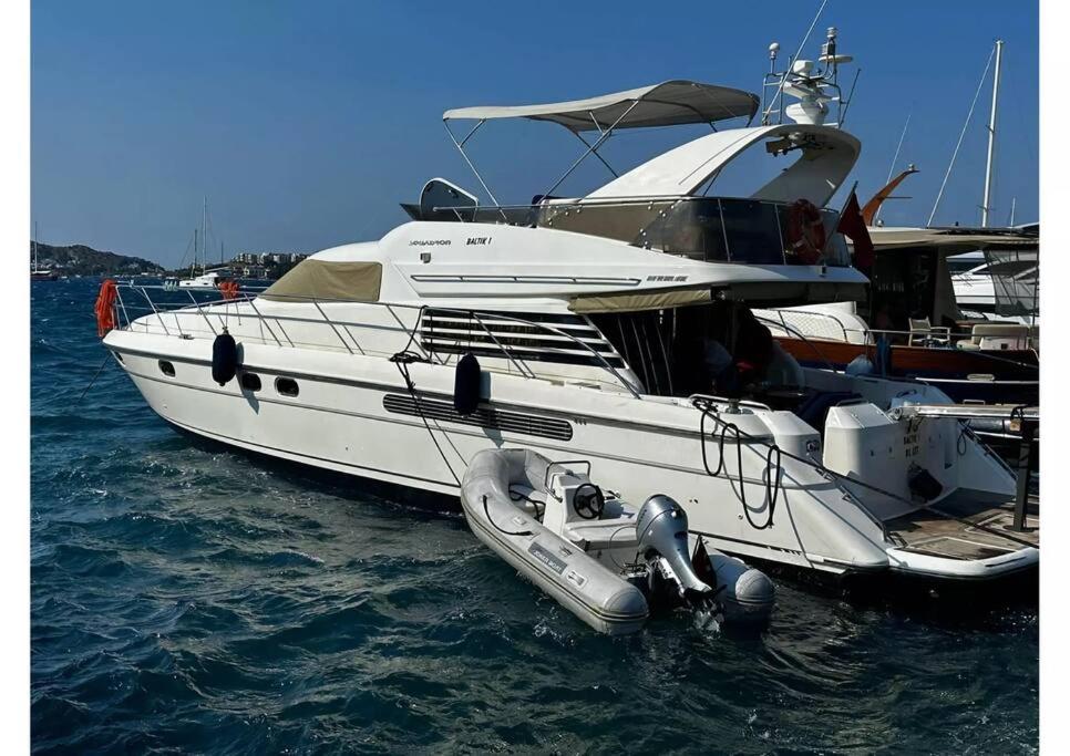 a white boat is docked in the water at Bodrum Yacht Rental in Yalikavak in Bodrum City