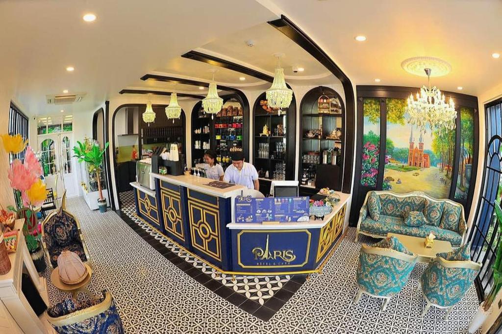 a restaurant with a bar in the middle of a room at Paris Hotel & Cafe in Vĩnh Long
