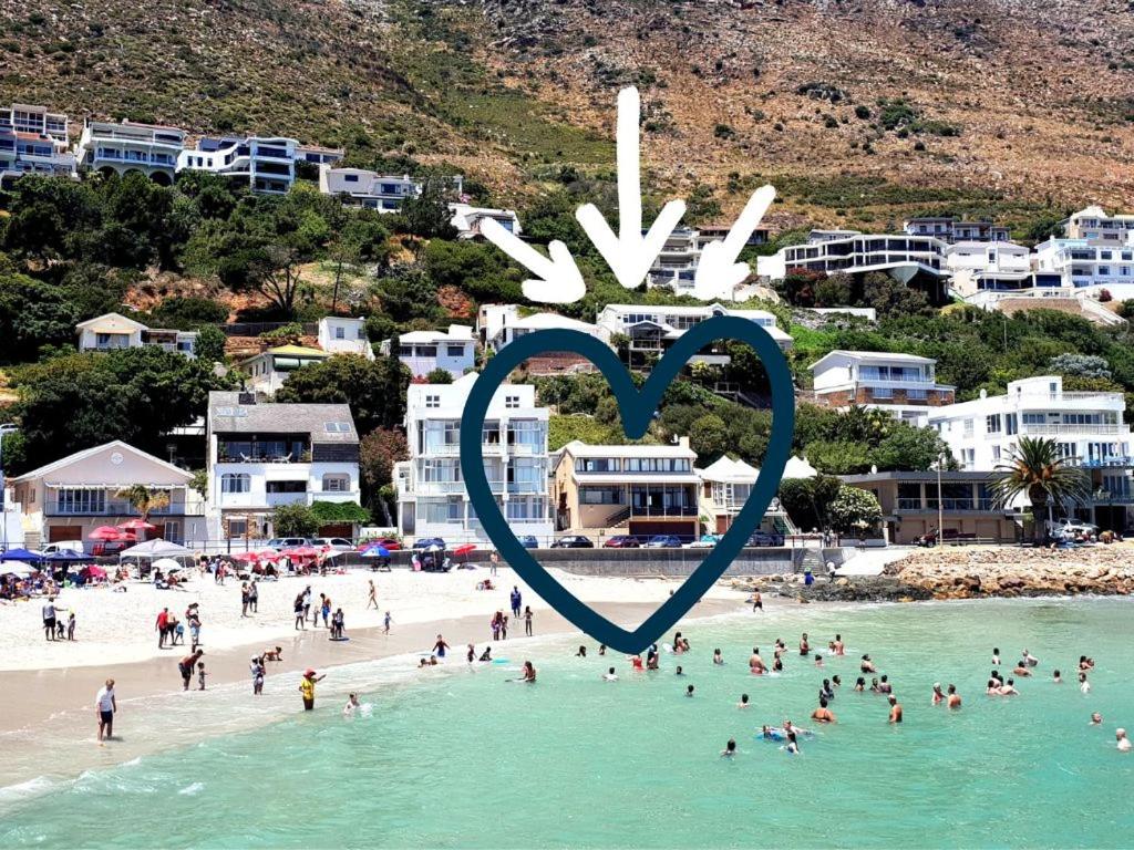 a heart sign in the water at a beach at Bikini Beach Holiday Home, On the Beach, Sleeps 9! in Gordonʼs Bay