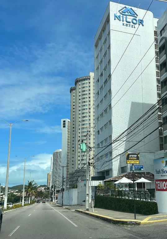 an empty street in front of a large building at Flat Praia de PontaNegra - Natal RN in Natal