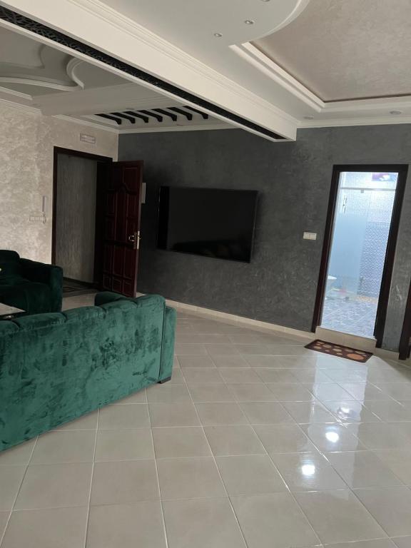 Appartement tarik : غرفة معيشة بها أريكة وتلفزيون