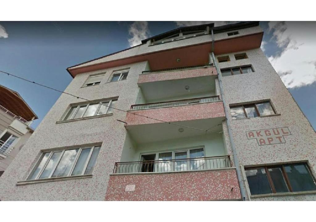 a tall building with windows on the side of it at Furnished rooms for students and youth in Sivas