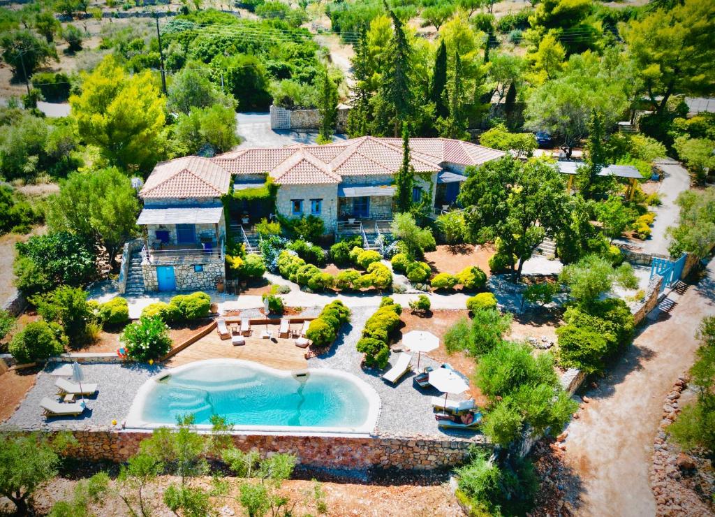 an aerial view of a house with a swimming pool at Strofilia Stone Residences in Volimes