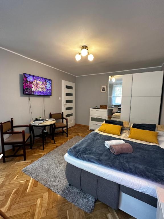 a bedroom with a large bed and a dining room at Gdańsk Sea Apartment in Gdańsk