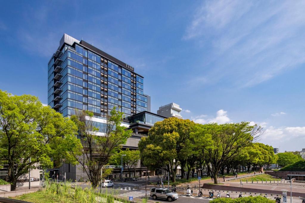 a tall building with trees in front of it at TIAD, Autograph Collection in Nagoya