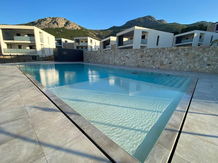 a swimming pool in the middle of a building at Exceptionnelle Vue Mer Calvi - Piscine - T2 in Calvi