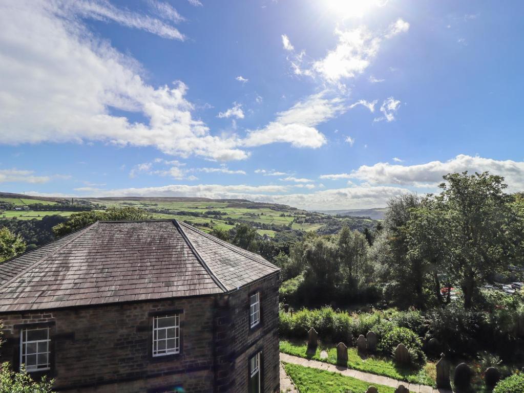 an old house with a view of the countryside at Weaver's View in Hebden Bridge