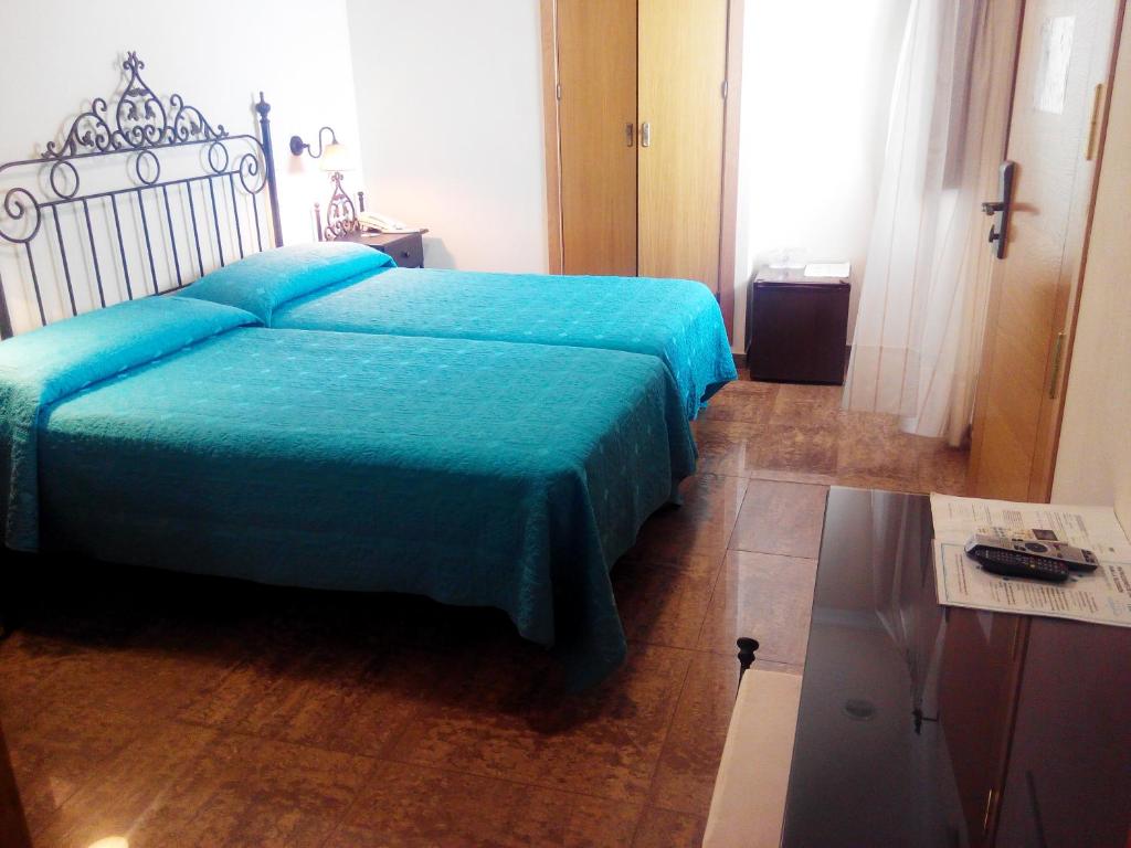 Postel nebo postele na pokoji v ubytování Hotel Plaza Escribano