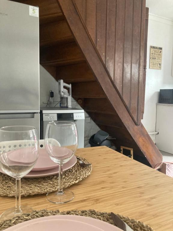 two wine glasses sitting on a table in a kitchen at Charmante petite maison à Olne in Olne