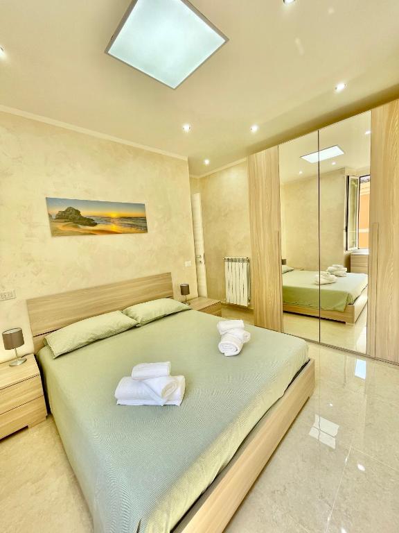 a bedroom with a large bed with towels on it at Casa vacanza l’archetto in Genzano di Roma