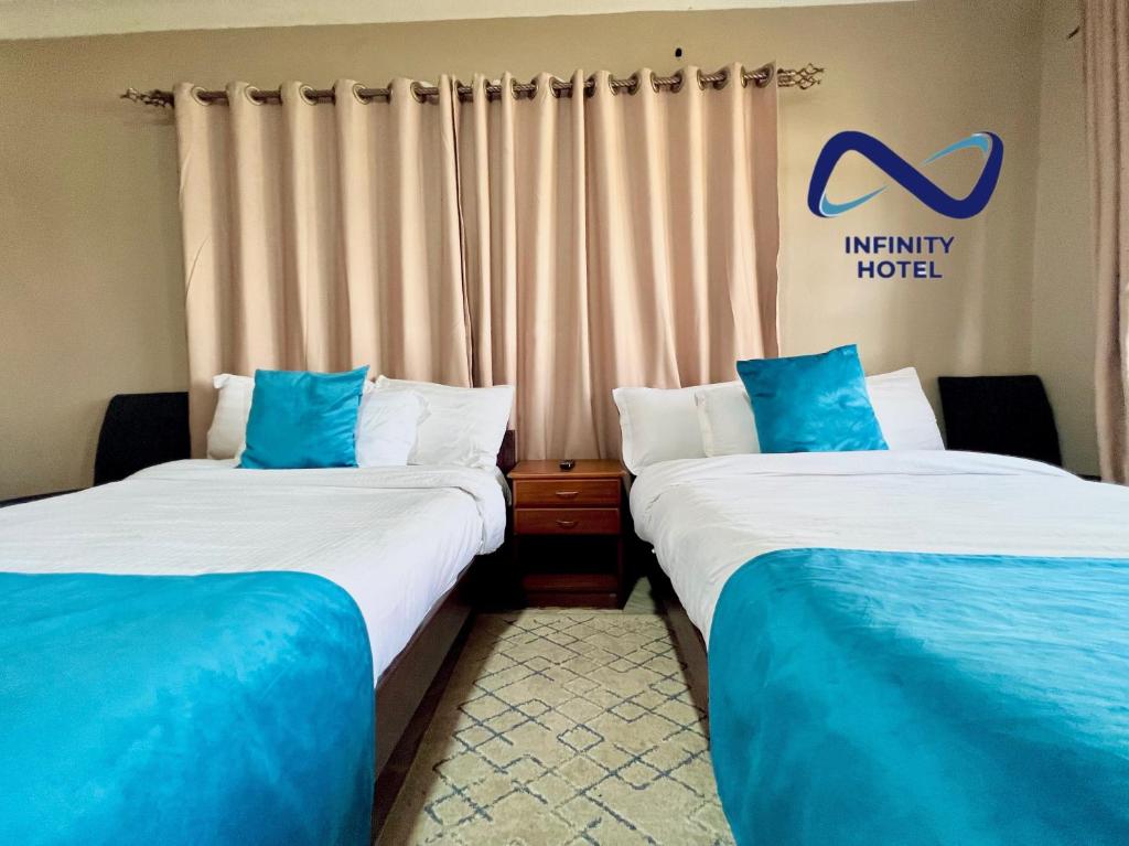 Postel nebo postele na pokoji v ubytování Infinity Hotel Kampala