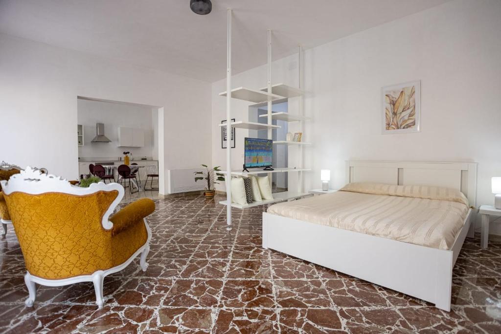 a bedroom with a bed and a chair at Al 26 Apartment in Erice