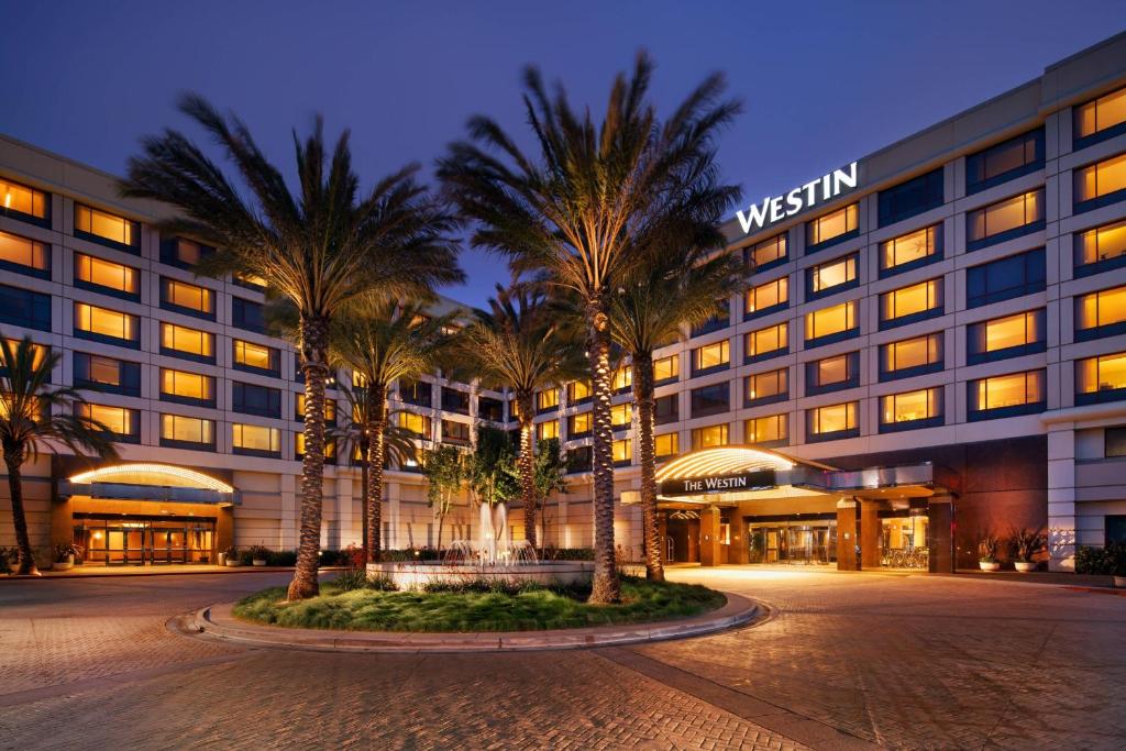 a hotel with palm trees in front of a building at The Westin San Francisco Airport in Millbrae