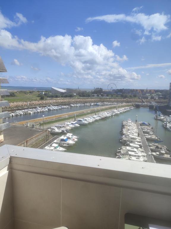 a view of a marina with boats in the water at Appartement liberty in Courseulles-sur-Mer