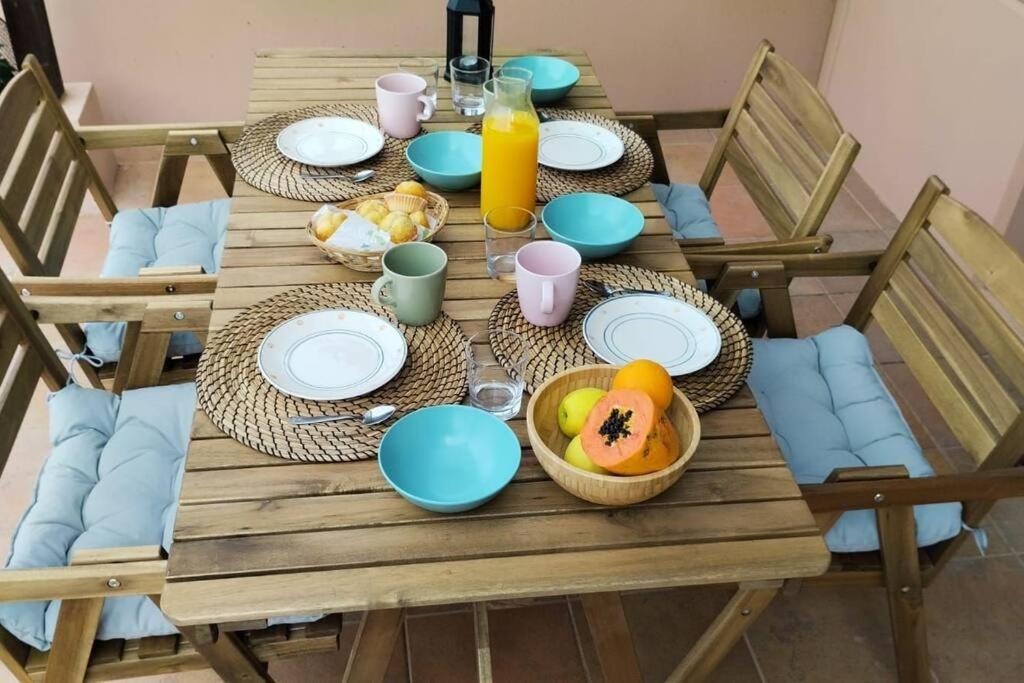 a wooden table with plates of food on it at Vivienda en Lajares " Casa Sua " in La Oliva