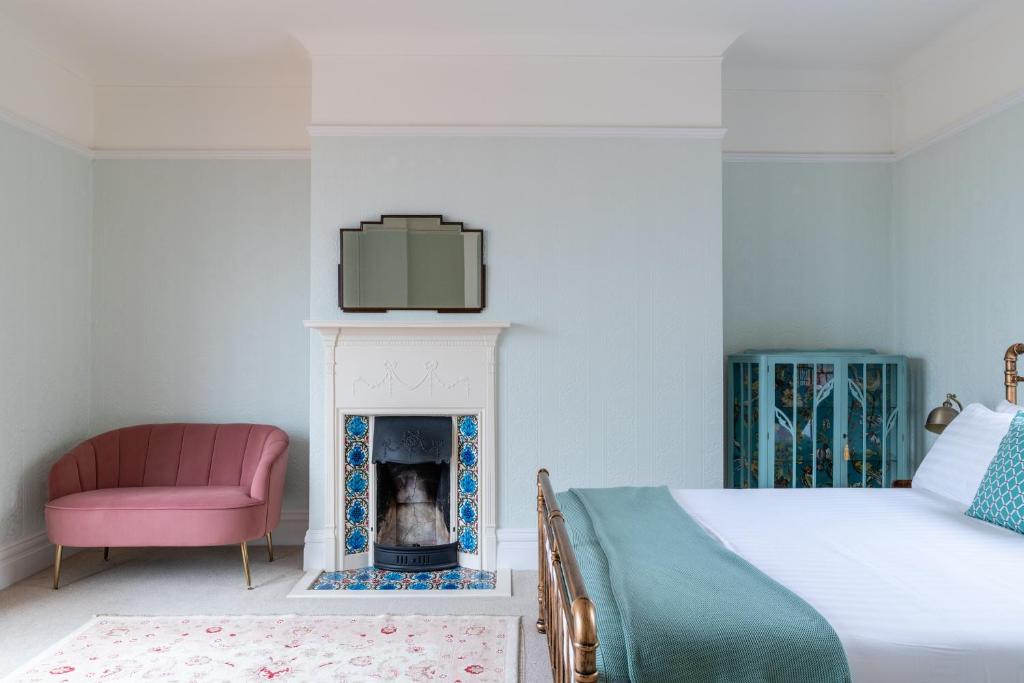 a bedroom with a bed and a fireplace at Magnificent house with Harbour view - Ramsgate in Ramsgate