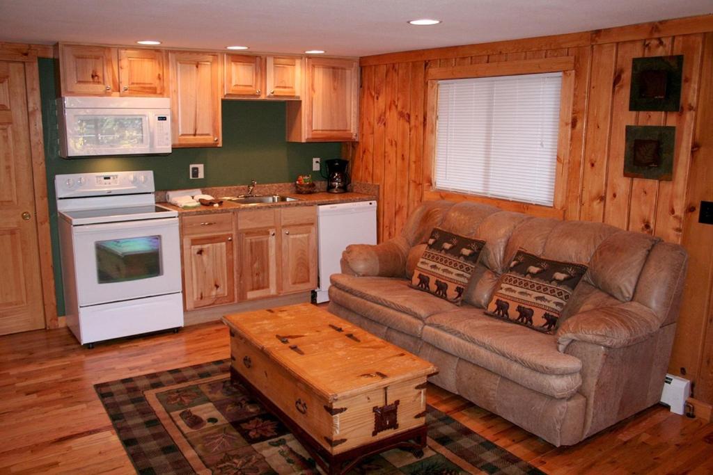 Timber Creek Chalets- 10A chalet في استيس بارك: غرفة معيشة مع أريكة وطاولة