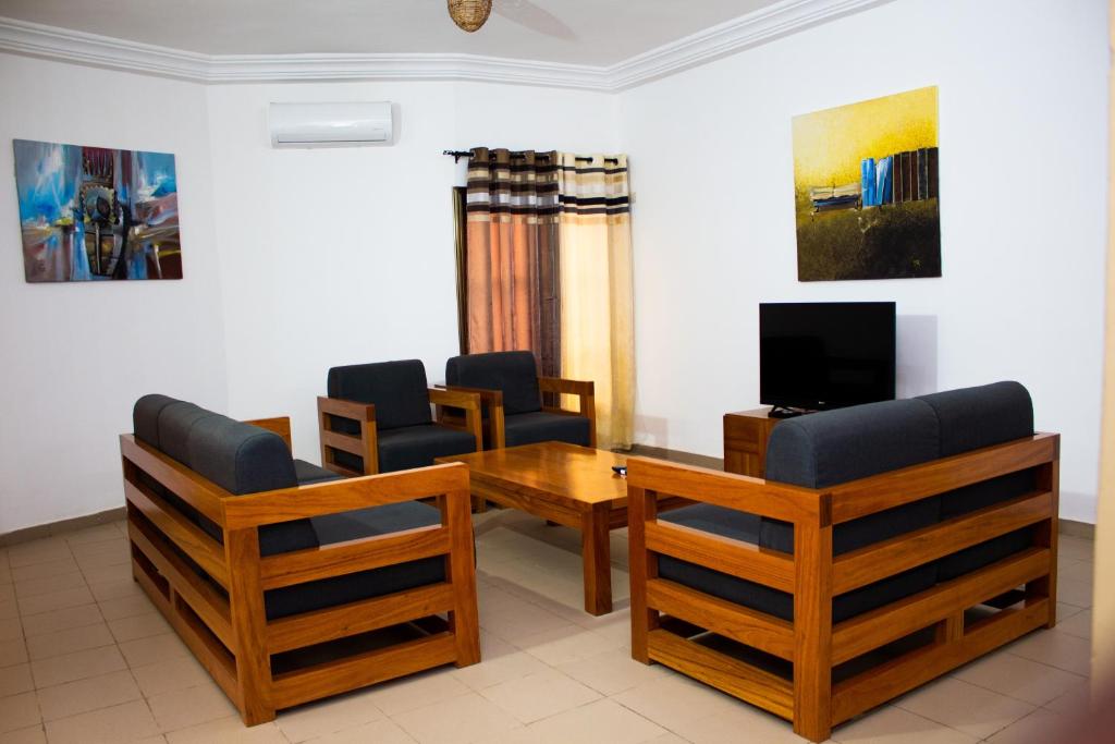 a waiting room with chairs and a table and a tv at ORADYS RESIDENCE 