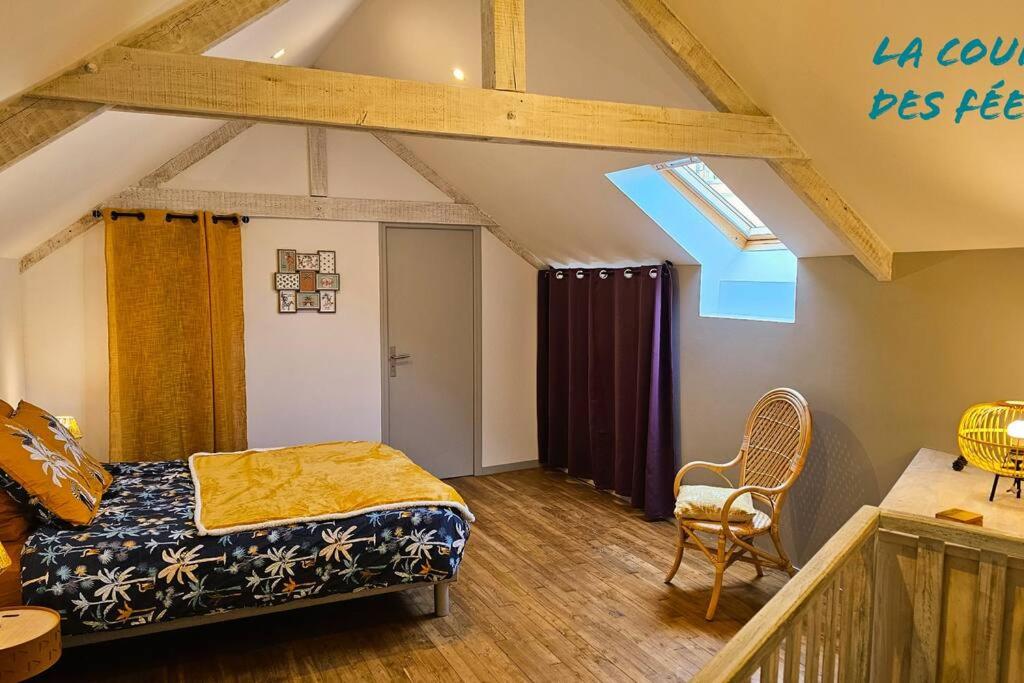 a bedroom with a bed and a chair in a room at Appartement La Roche-Bernard - Plein centre - 50m² in La Roche-Bernard