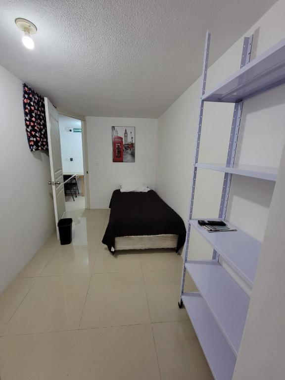 a bedroom with a bed and a ladder in a room at (2) cuarto maravilloso para descansar y asearse in Tlazcalancingo