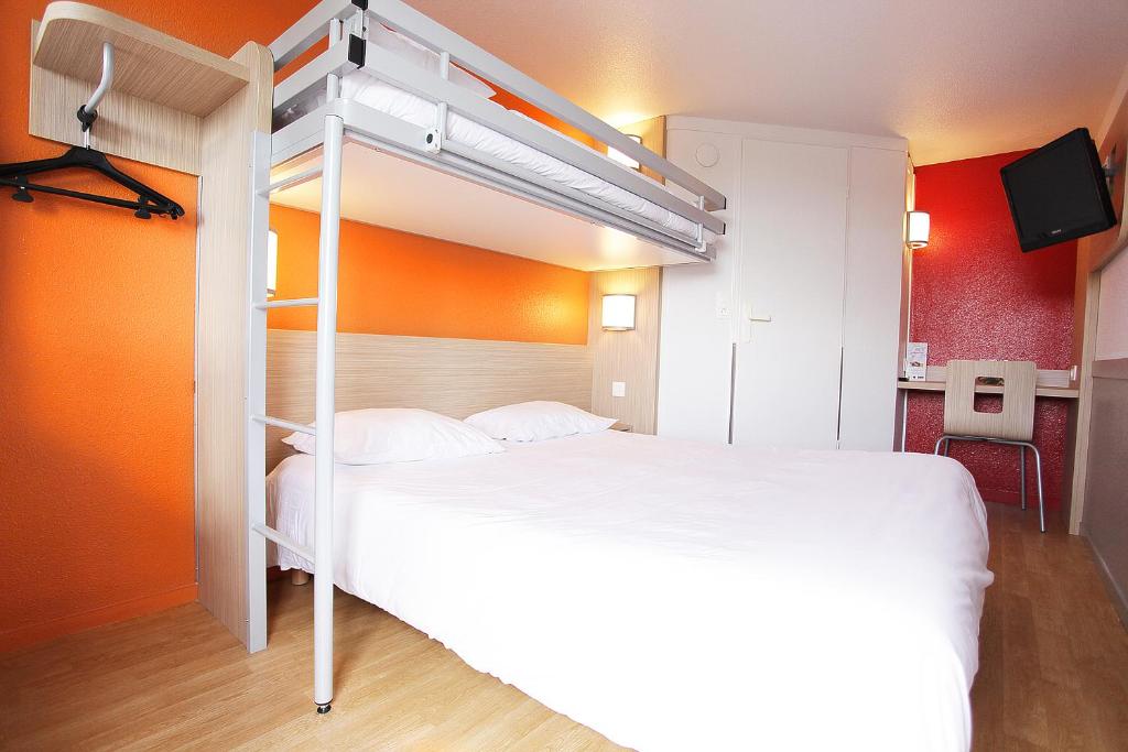 a bedroom with a bed with a bunk bed at Premiere Classe St Brieuc Tregueux in Tregueux