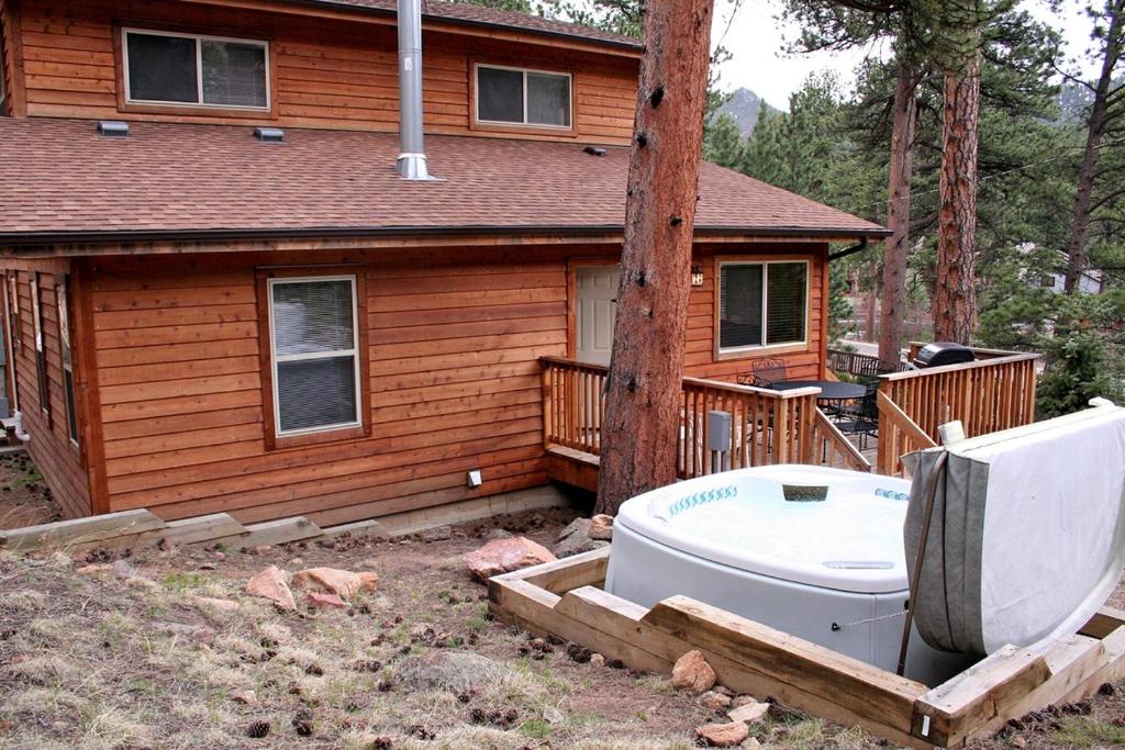 a bath tub sitting in front of a house at Timber Creek Chalets- 9 chalet in Estes Park