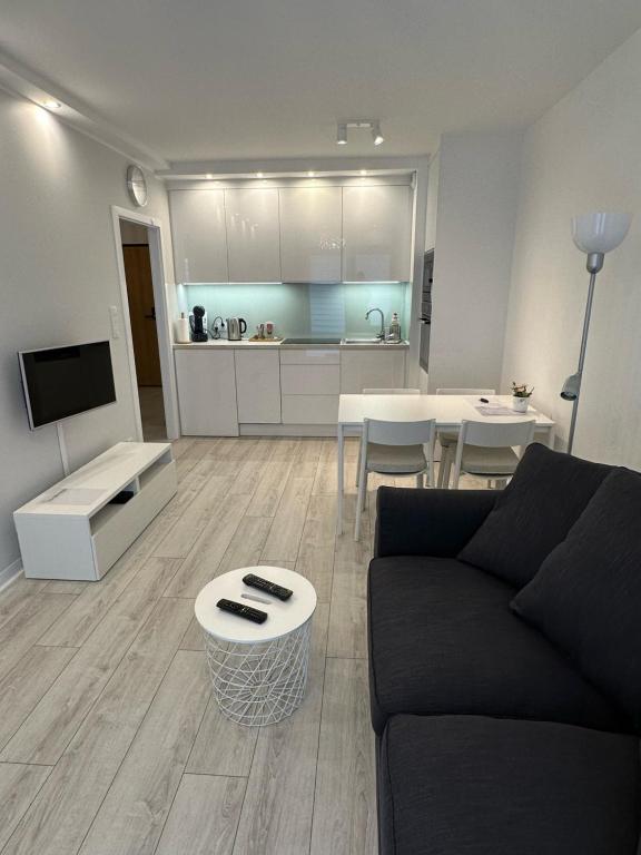 a living room with a couch and a table at Flat4You IV in Poznań