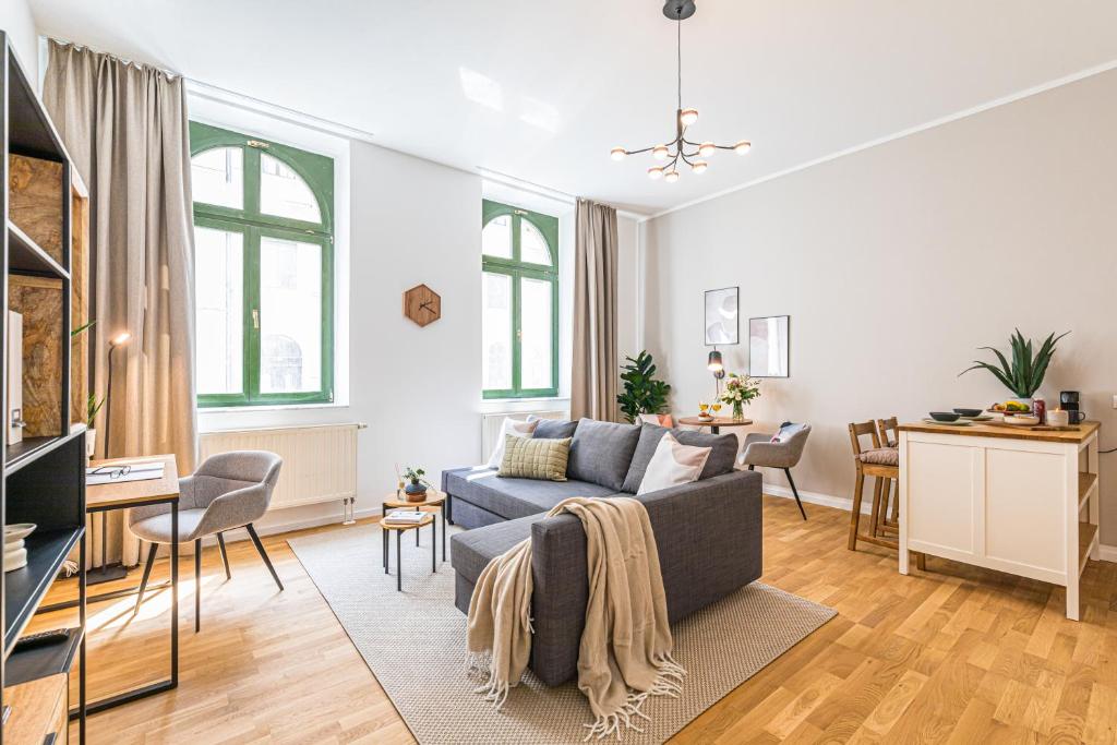 a living room with a couch and a table at Luxury Style 2 Room Apartment by R&L in Centre in Leipzig