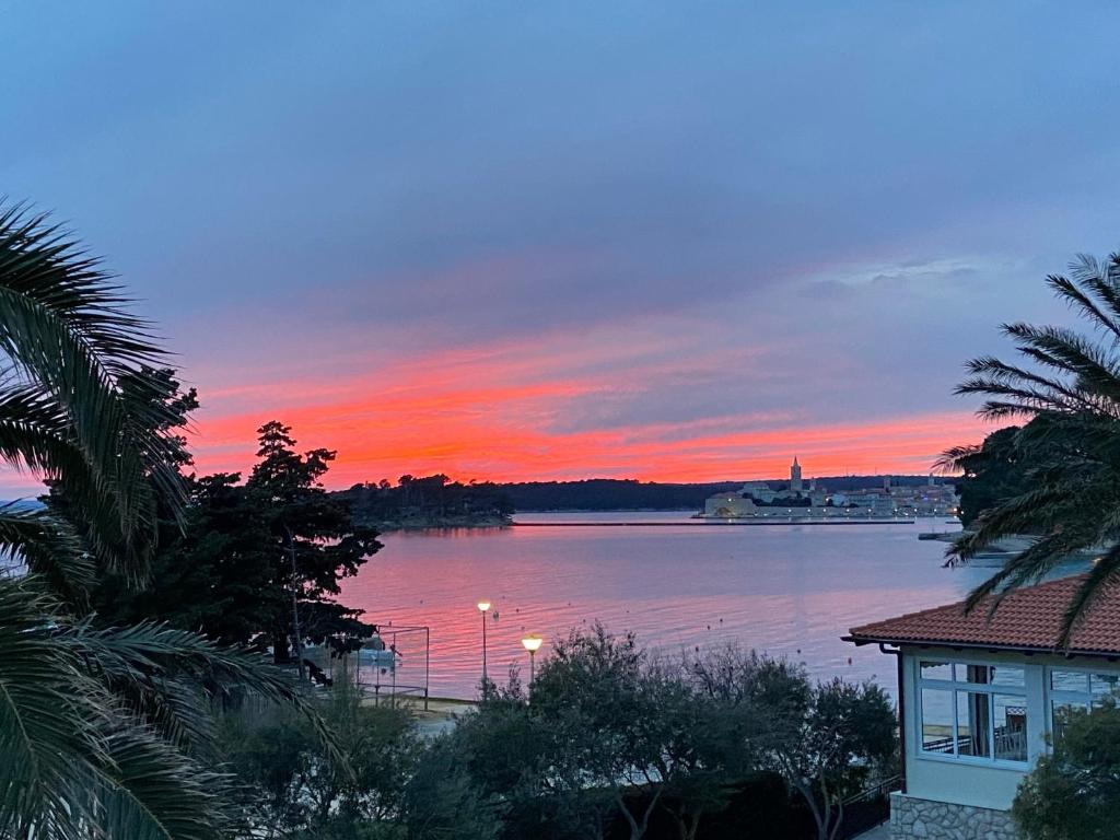 a sunset over a large body of water at Apartments Flora 1 in Rab