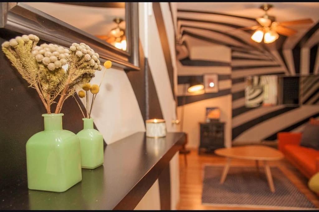 two green vases sitting on a counter in a living room at Artistic 2BR in NYC in New York