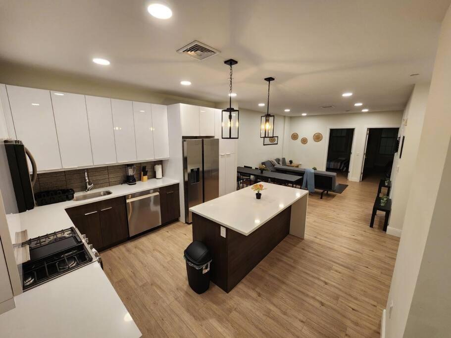 a large kitchen with white cabinets and a kitchen island at Deluxe 2 Bedroom VIP to NYC in Union City