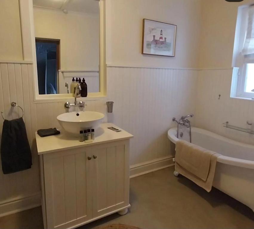 a bathroom with a sink and a bath tub at 6 Olives B&B in Darling