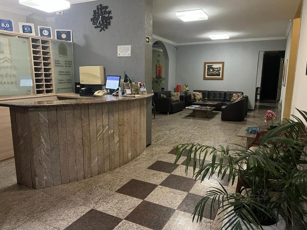 a lobby with a counter and a living room at Aldeota Praia Hotel in Fortaleza