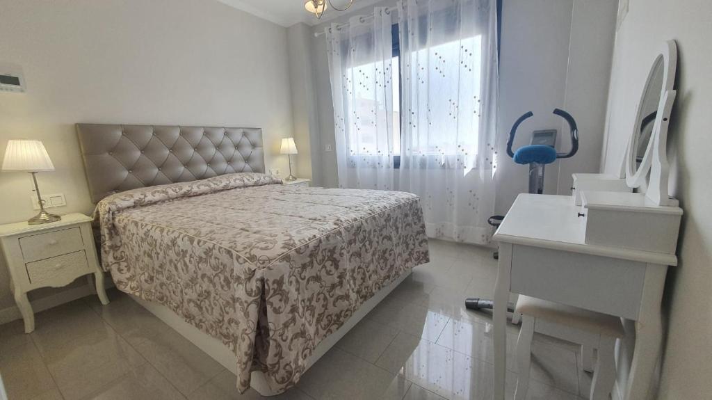 a bedroom with a bed and a sink and a window at LA MARINA in Torre del Mar