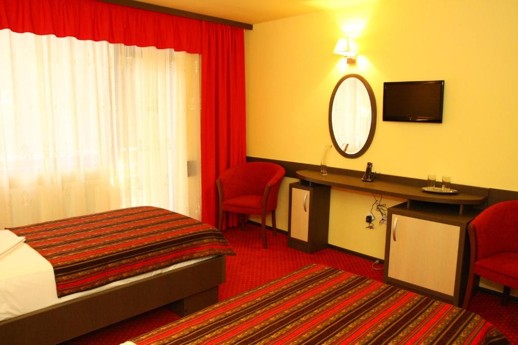 Postel nebo postele na pokoji v ubytování Hotel Dana