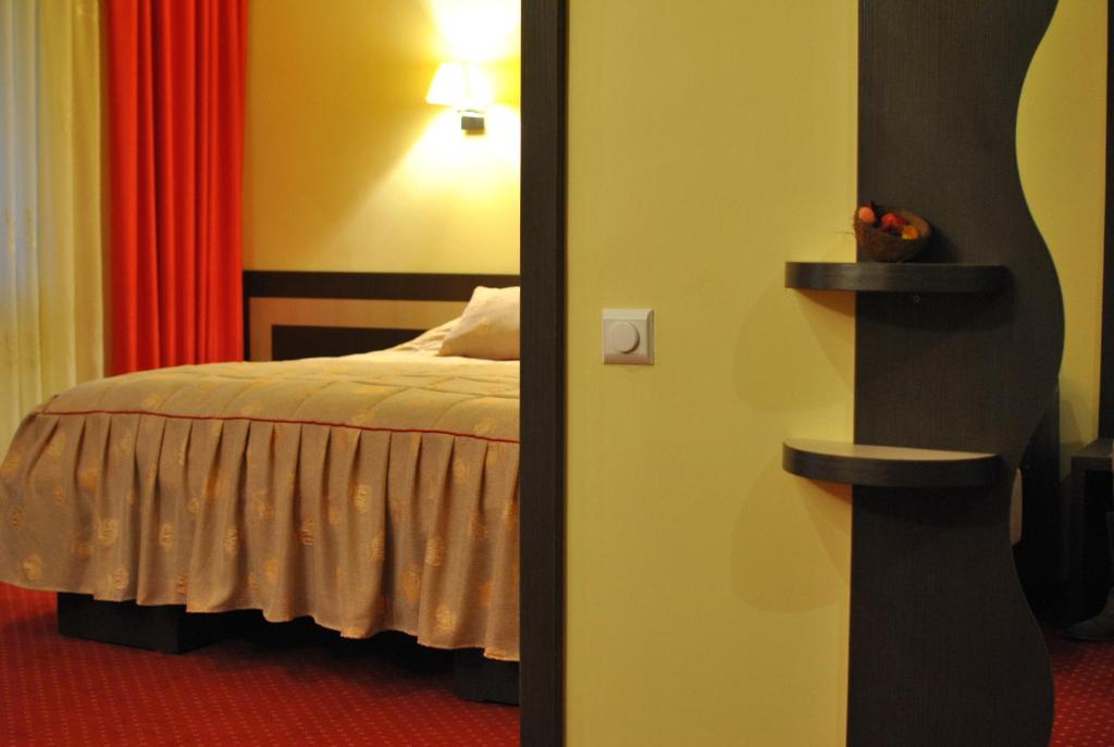Postel nebo postele na pokoji v ubytování Hotel Dana
