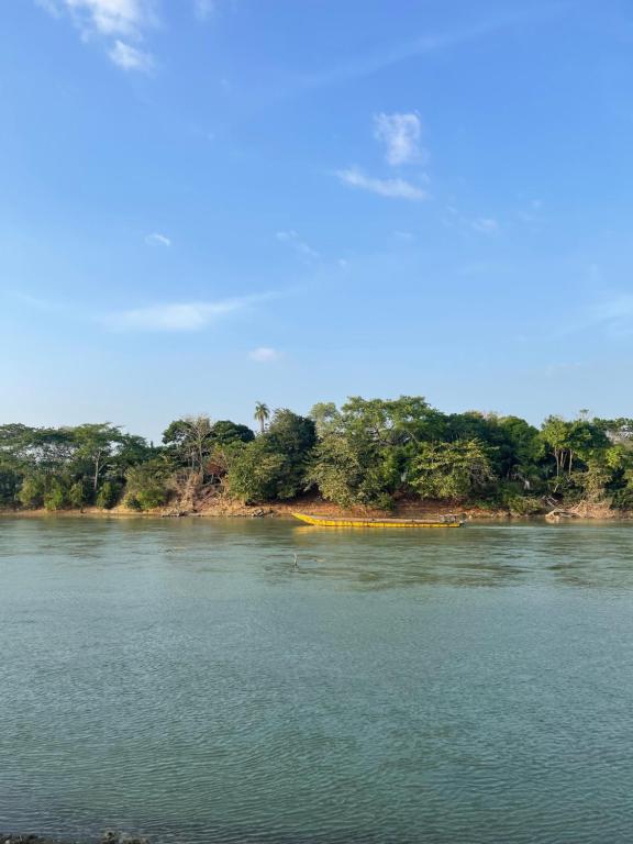 a body of water with trees in the background at Casa Del Río in Montería