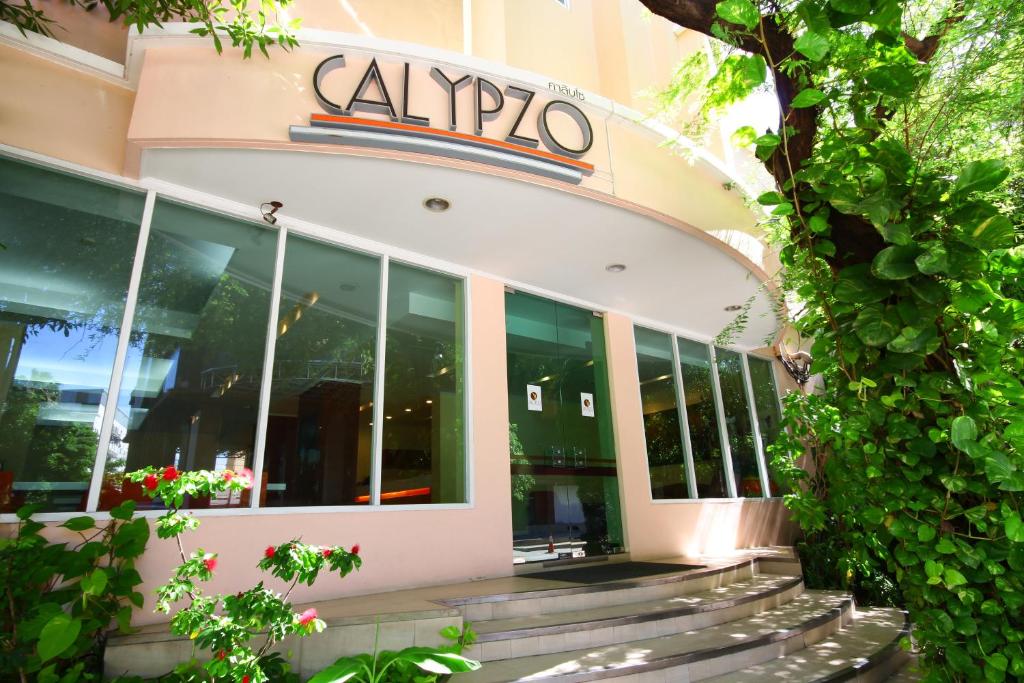 a building with a sign on the front of it at Calypzo Bangkok in Bangkok