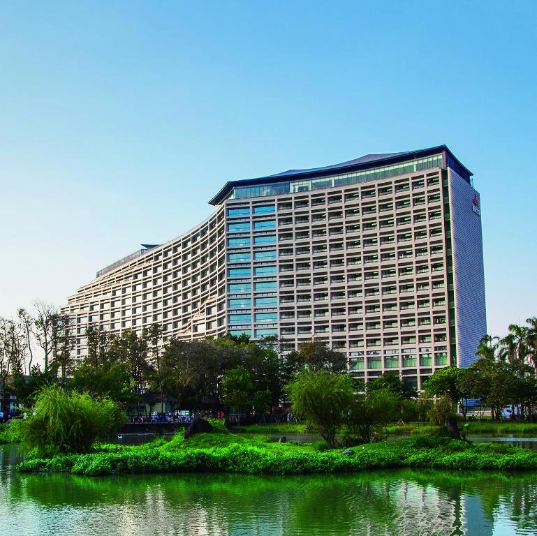 a large building with a pond in front of it at Eslite Hotel in Taipei