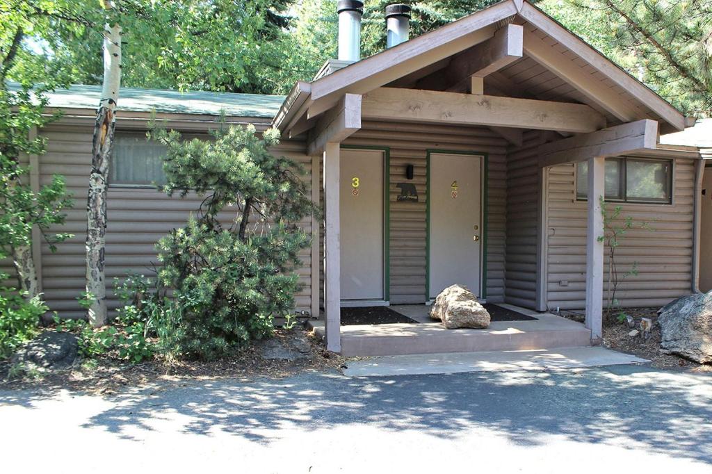 a small house with a porch and a door at Sunnyside Knoll- 3 studio in Estes Park